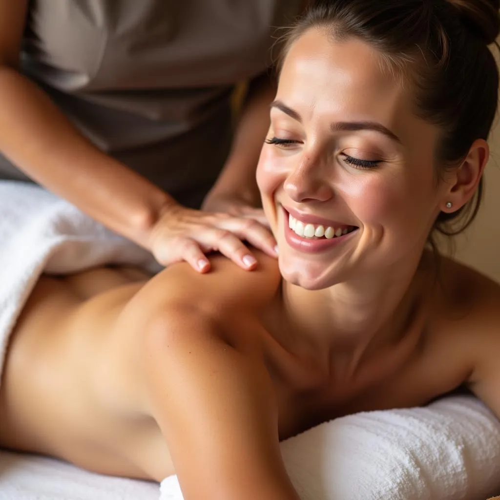 Happy client enjoying a massage at Amanvana Spa