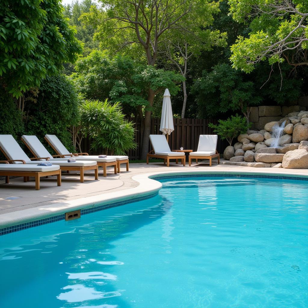 Spa Relaxation Area with Pool: A tranquil pool area surrounded by comfortable loungers and lush greenery, offering a serene escape for guests to unwind and rejuvenate.